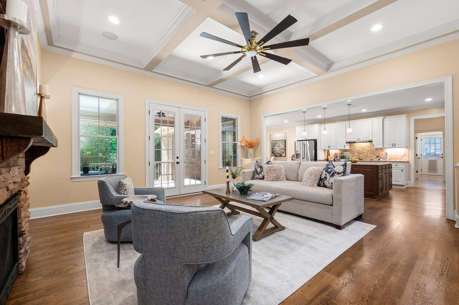 Coffered great room with floor-to-ceiling stone fireplace