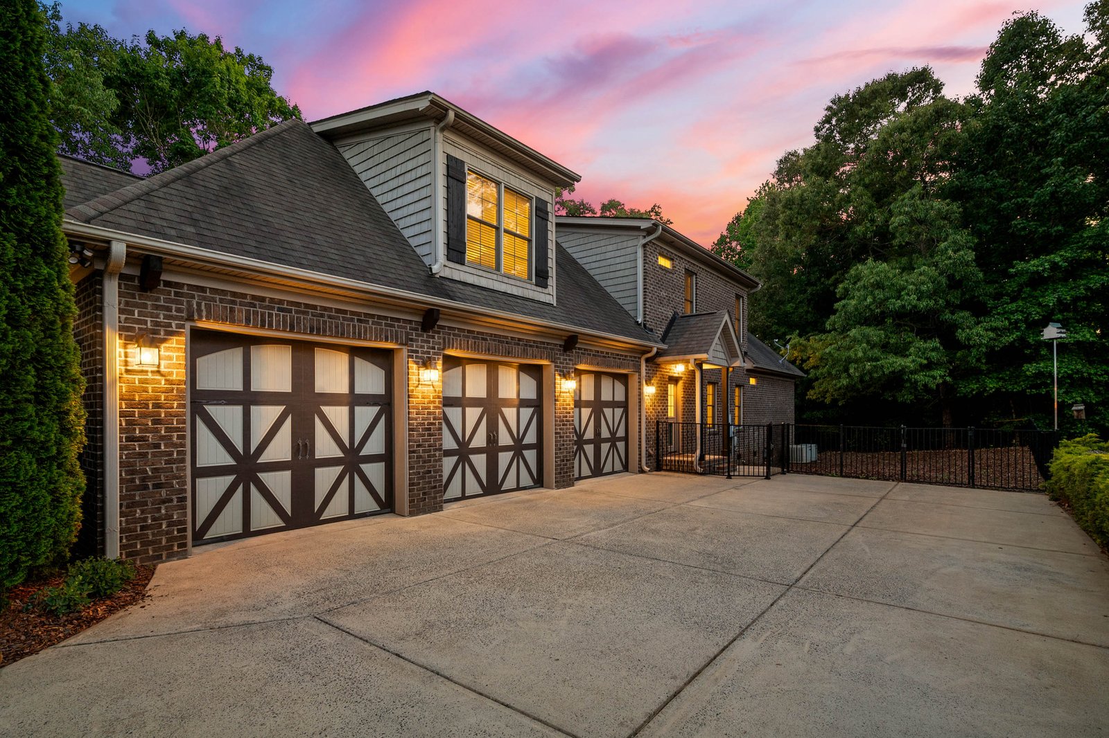 Side-entry three-car garage at sunset